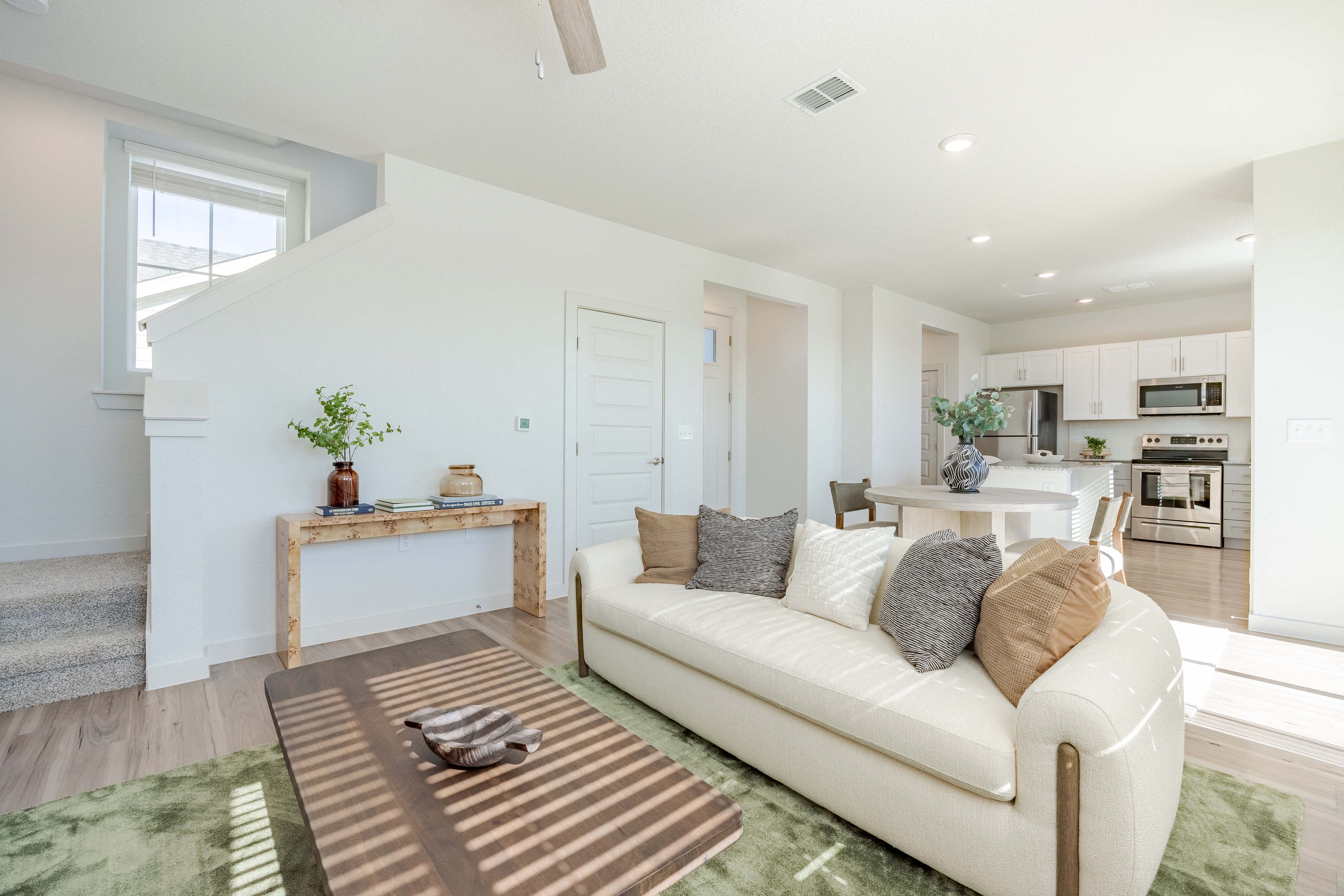 A living room with a white couch and a coffee table.